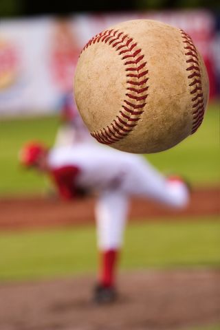 Baseball player throws a pitch.