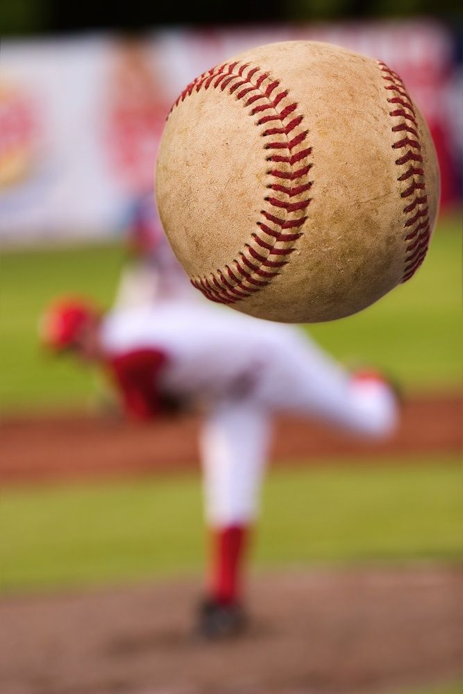 Baseball player throws a pitch.