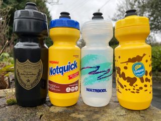 The best cycling water bottles from Watrbodl in a line on a wall