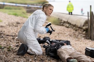 Nikki inspects a body on a beach in Silent Witness season 27