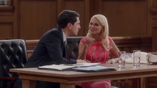 a man and woman sit at a desk in a court room. in the tv show trial and error