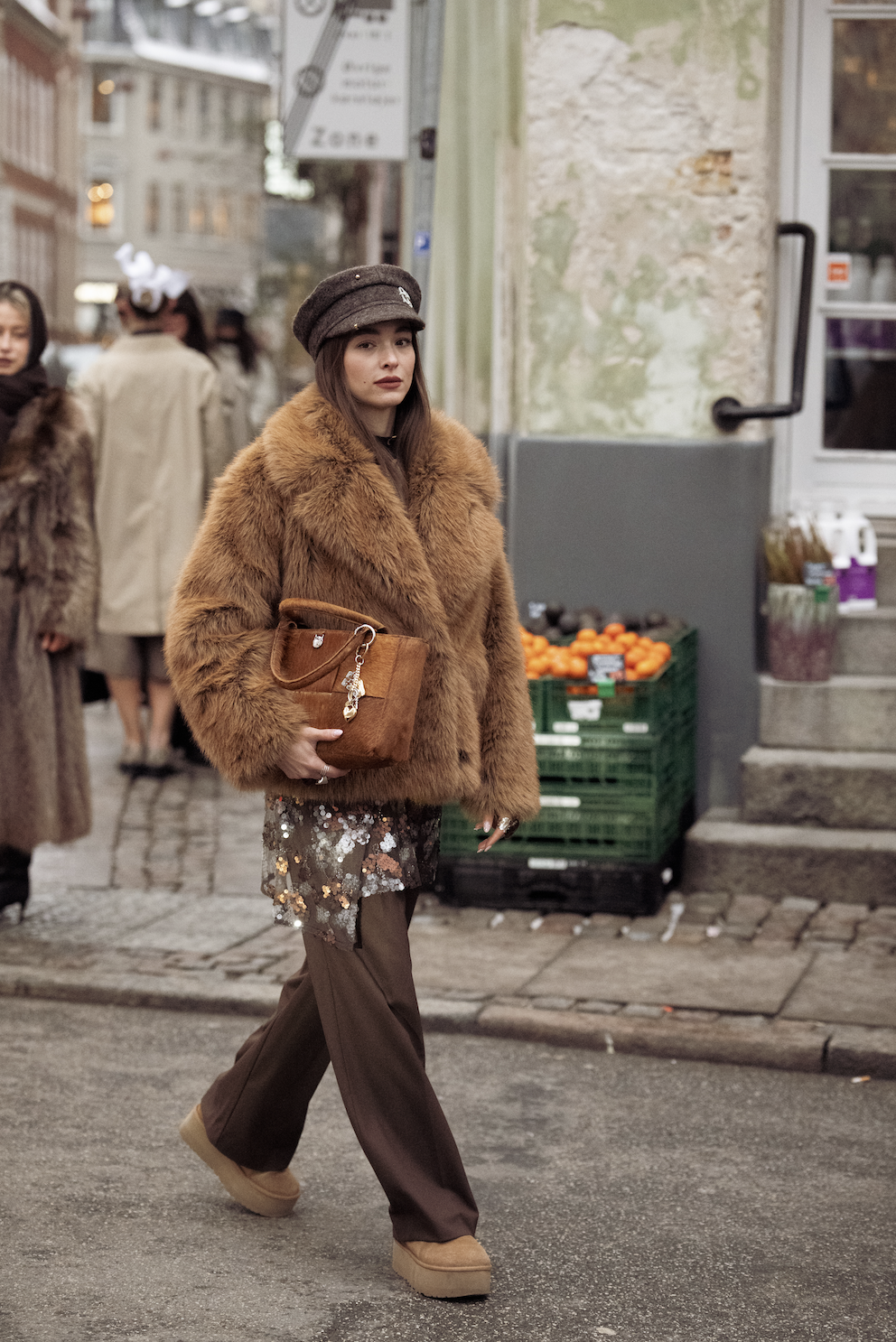 COPENHAGEN, DENMARK - JANUARY 28: Evi Wave wears dark brown pants, brown suede boots, brown embroidered skirt, brown fur jacket, brown suede bag and dark brown paper boy hat outside the MKDT Studio show during Copenhagen Fashion Week AW26 on January 28, 2026 in Copenhagen, Denmark. (Photo by Raimonda Kulikauskiene/WireImage)