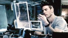 The movie "Minority Report" (2002) directed by Steven Spielberg. Seen here, Tom Cruise (as Chief John Anderton) in his home, seated at computer information screens.