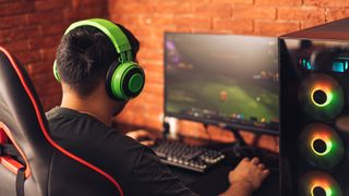 Gamer wearing headphones whilst gaming on desktop PC
