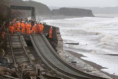 DAWLISH, UNITED KINGDOM - FEBRUARY 05:Railway workers inspect the main Exeter to Plymouth railway line that has been closed due to parts of it being washed away by the sea at Dawlish on Febru
