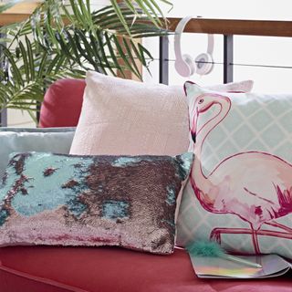 pink sofa with patterned cushions