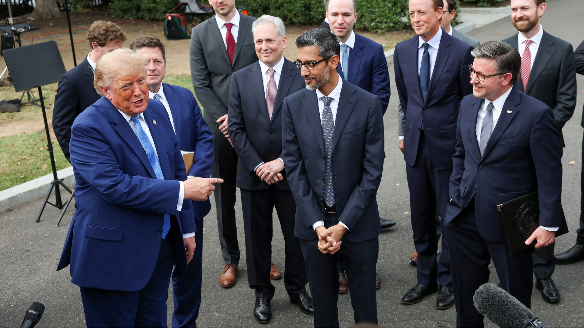 President Donald Trump talking to the press with various AI industry leaders around him