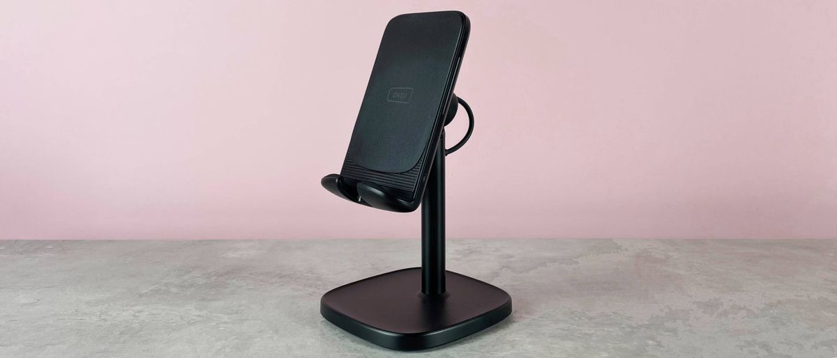 The INIU I212 Adjustable Wireless Charger is pictured sitting on a grey stone surface against a pink background.