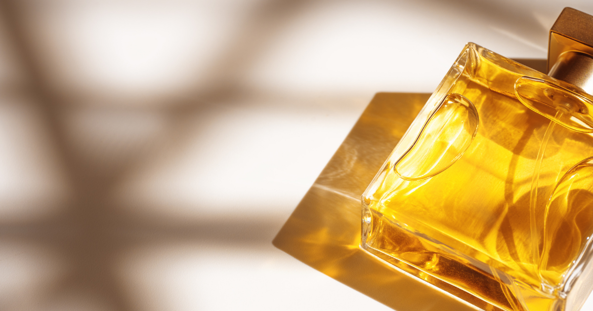 Unlikeable fragrance: glass bottle Perfume in a glass transparent bottle with caustic Light effect on white beige