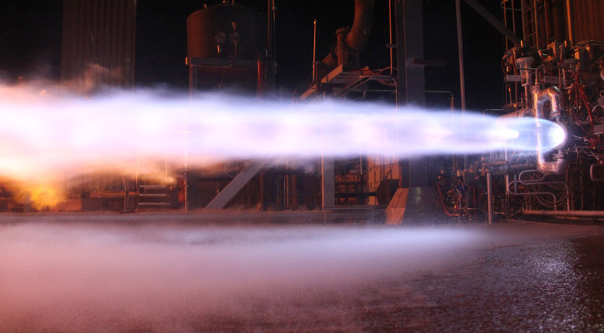 flash of blue, white and orange flames streak across the image as the BE-4 engine is tested.