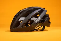 Lazer G1 Genesis helmet is pictured side on with the left to right on an orange background