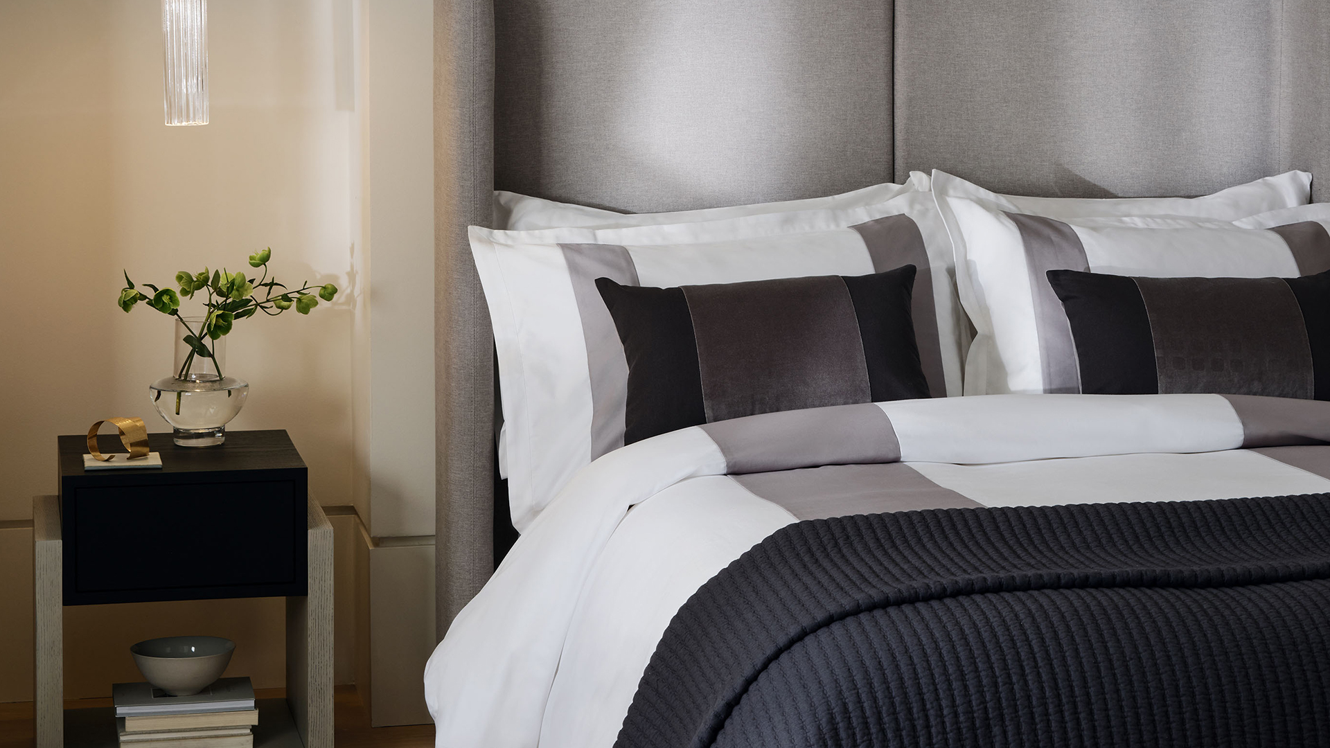 Monochrome bedroom with bed dressed by Kelly Hoppen