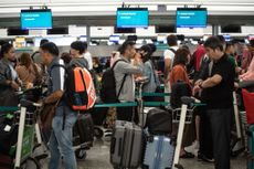 Travelers at the Hong Kong International Airport on Wednesday.