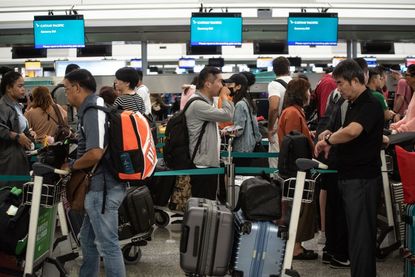 Travelers at the Hong Kong International Airport on Wednesday.