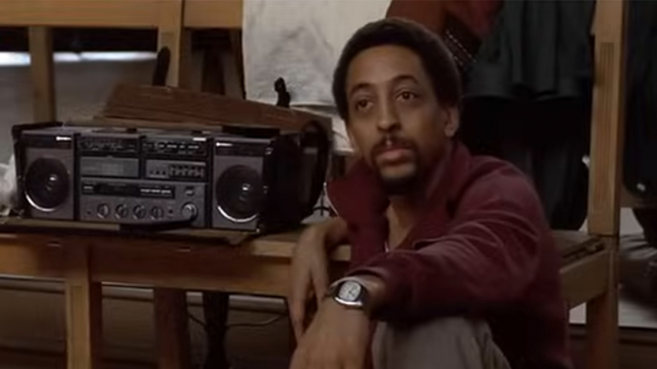 Greegory Hines sitting next to a boom box in White Nights