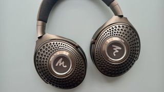 Focal Bathys Mg in bronze, featuring ear cup detail on gray background