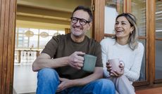 Couple enjoying coffee on a terrace at home