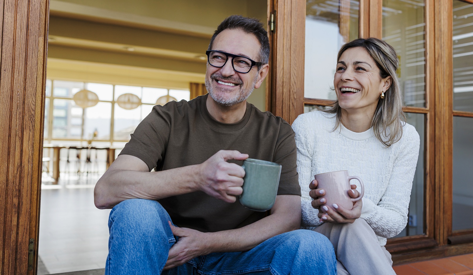 Couple enjoying coffee on a terrace at home