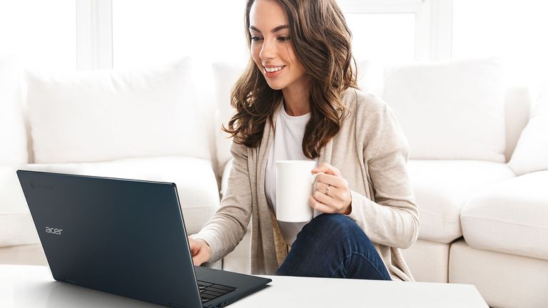 The best Chromebooks hero image showing a woman using a Acer Chromebook Spin 513 while drinking a hot beverage