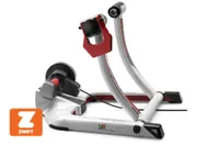 Elite Qubo Power B+ Smart Turbo Trainer in the image is un-folded and ready to have a bike placed in-between the two uprights. 