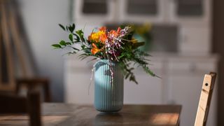 Vase of flowers on table in the sunshine