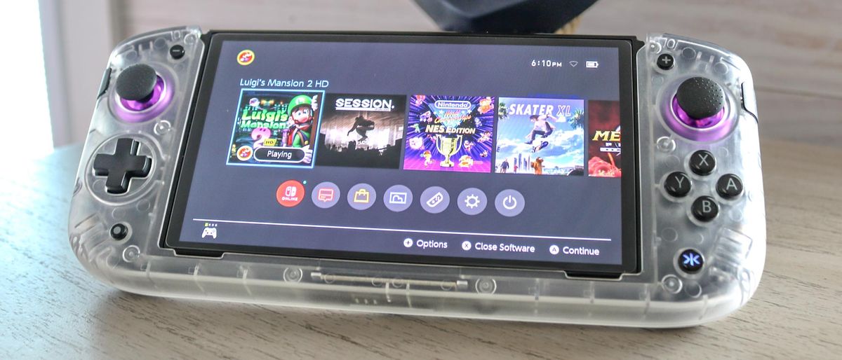 A Nintendo Switch in the CRKD Nitro Deck+ controller on a table