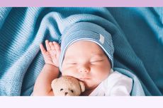 Oliver knocked off the top spot as most popular boy's name, seen here is a newborn baby boy sleeping peacefully with a cute soft toy