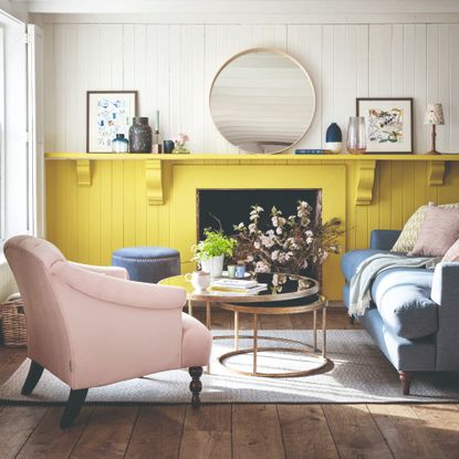 A living room with two-tone panelled walls in white and yellow and a ledge across the whole wall