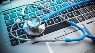 Stethoscope laying across a laptop keyboard