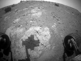 The robotic arm of NASA's Mars Exploration Rover Opportunity casts a shadow on a rock outcrop called "Chester Lake" in this image taken by the rover's front hazard-avoidance camera. The image was taken during the 2,710th Martian day, or sol, of Opportunity's work on Mars (Sept. 8, 2011).