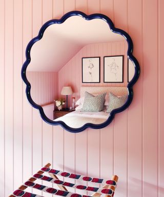 blue mirror in pink bedroom with pink paneling