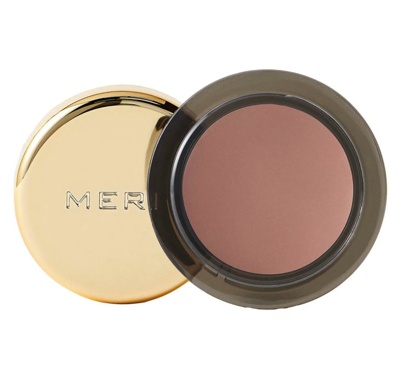 A product shot of the Merit Beauty Solo Shadow Cream Eyeshadow in the shade Studio (a cool muted taupe), on a white background
