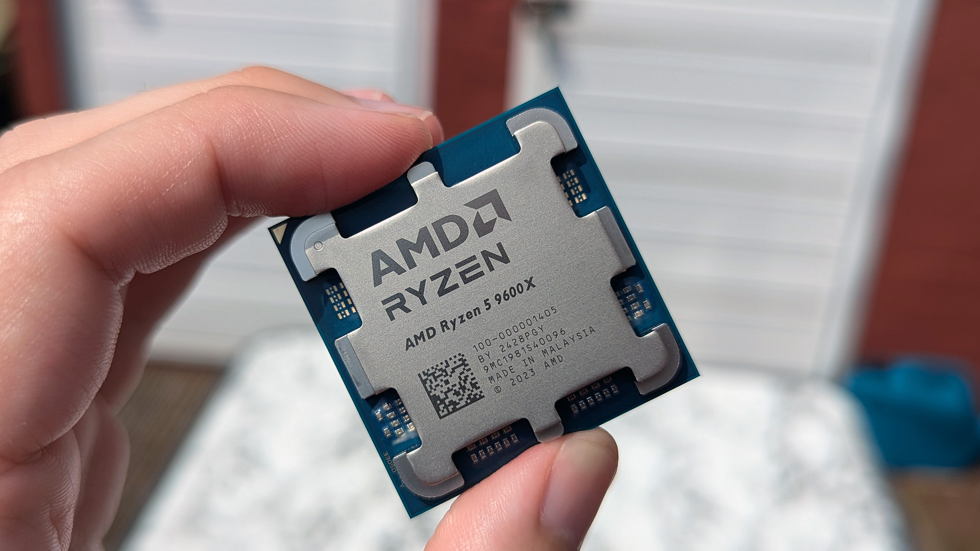 AMD Ryzen 5 9600X processor held in hand