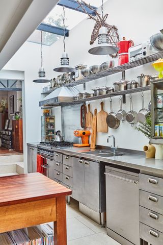 industrial style kitchen with stainless steel shelving as kitchen storage