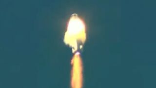 blue origin rocket in middle of a fireball during launch