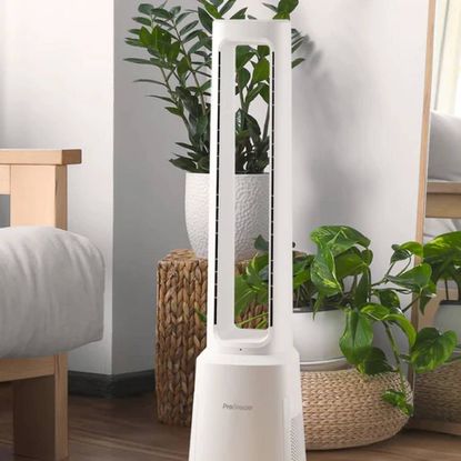 A Pro Breeze fan in a modern bedroom alongside some rattan baskets and plants.