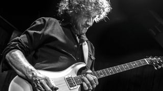 A black-and-white image of David Grissom playing his signature PRS