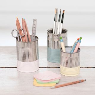 tin can with pen painting brushes and steel ruler