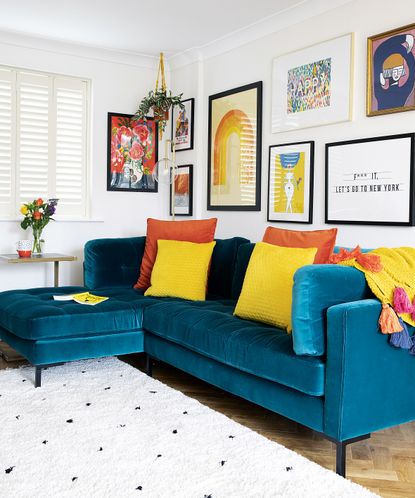 living room with blue sofa and orange and yellow cushions