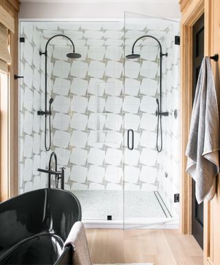 White and grey tiles. black shower heads and bath