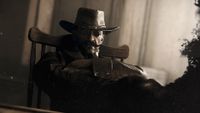 Hunt: Showdown promo image - cowboy in cool shades sitting with his arms crossed