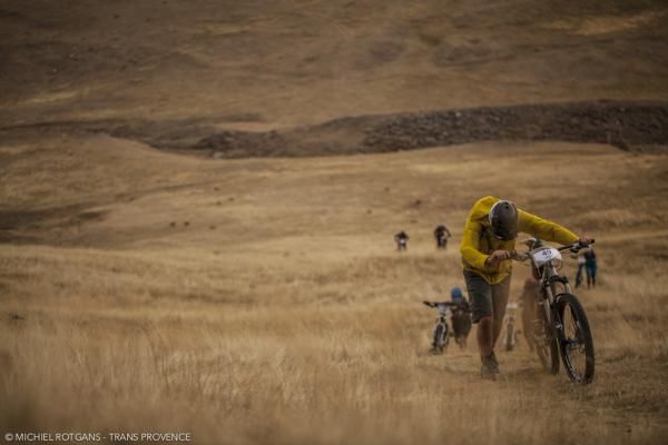 Racers walk their bikes