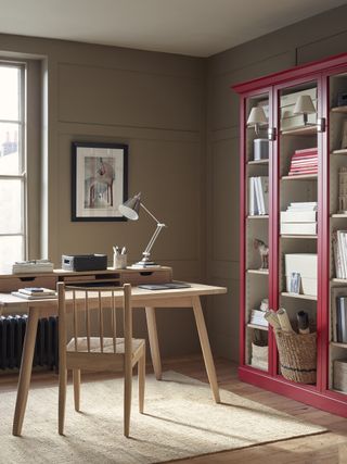 Home office design by Neptune with taupe walls and a red bookcase