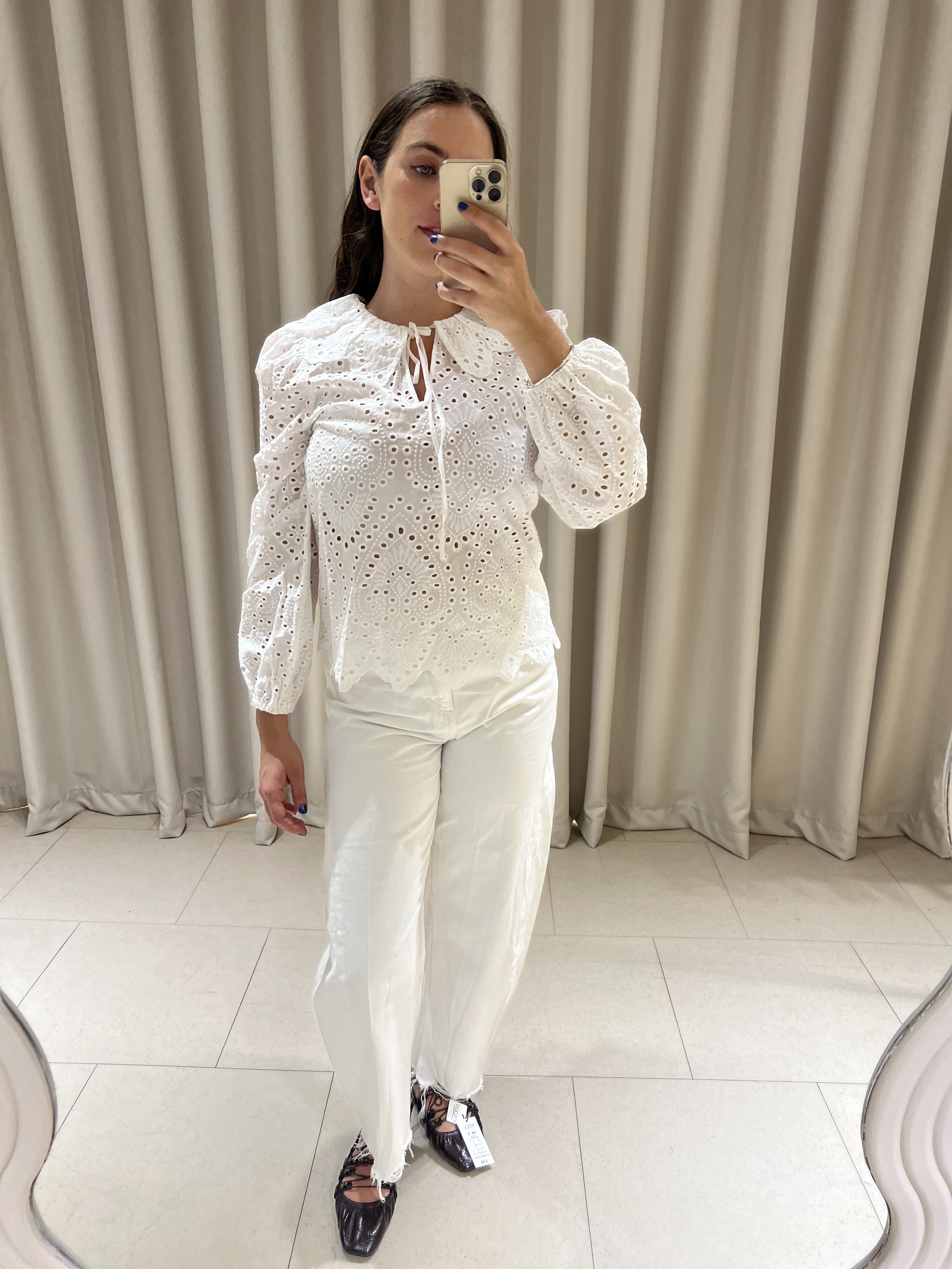 An image of Who What Wear UK fashion writer, Ava Gilchrist, wearing M&S's new Spring 2026 collection, which includes lace-up ballet flats, a Broderie Anglais blouse and white jeans.