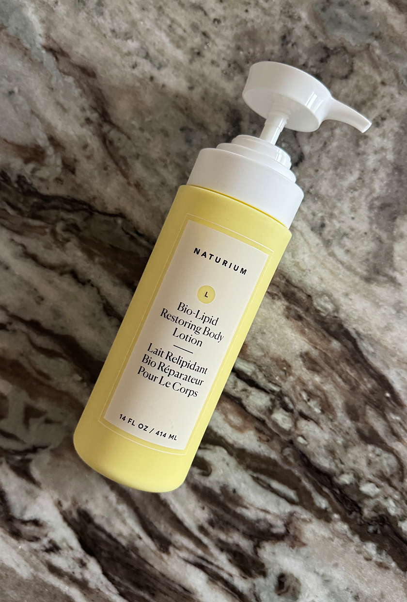 Naturium body lotion on a marble table