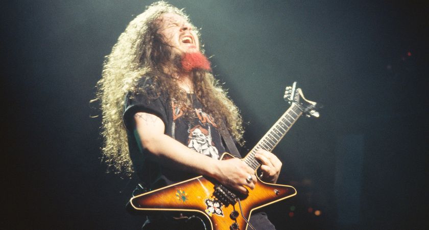 Dimebag Darrell plays a note and feels it as Pantera perform live in 1994. He is playing a tobacco burst Dean ML and has a red dyed goattee.