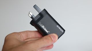 Anker Prime 100W charger held in a hand
