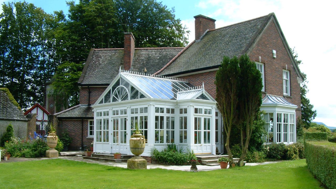 Exterior of brick house with white conservatory