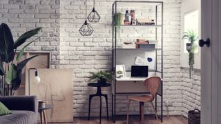 home office with painted exposed brick walls