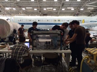 The team gets ready to load their experiment into a ZERO-G plane.